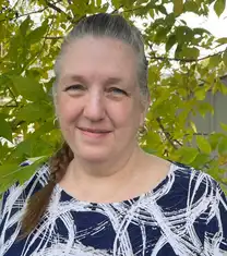 smiling lady with blue shirt