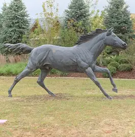 metal art horse running in the grass